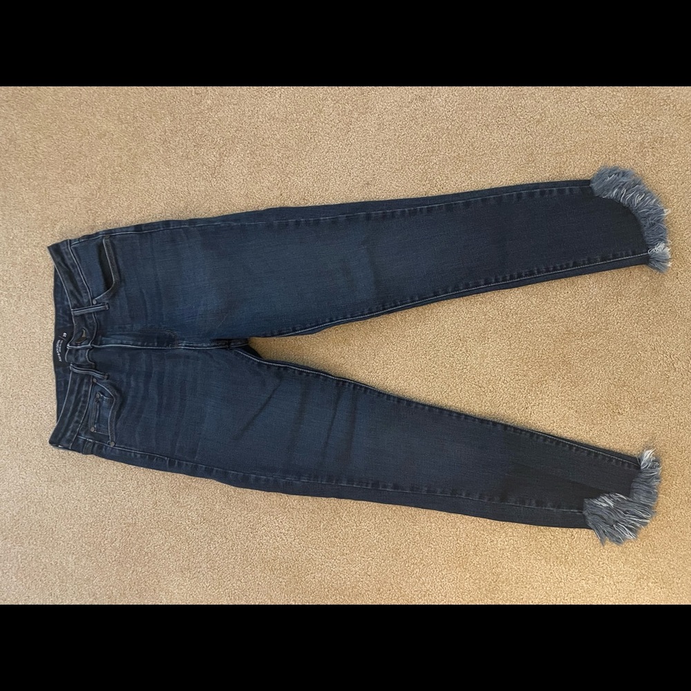 Blue jeans with fringed ankle